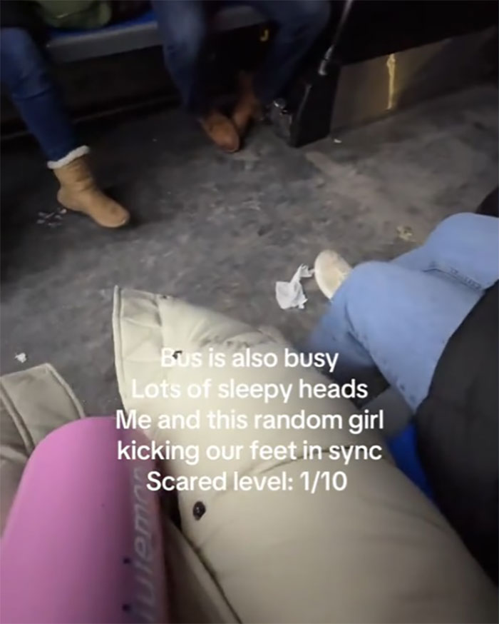 Woman on busy NYC bus at midnight, noting "scared level" as 1/10, with passengers wearing winter boots.