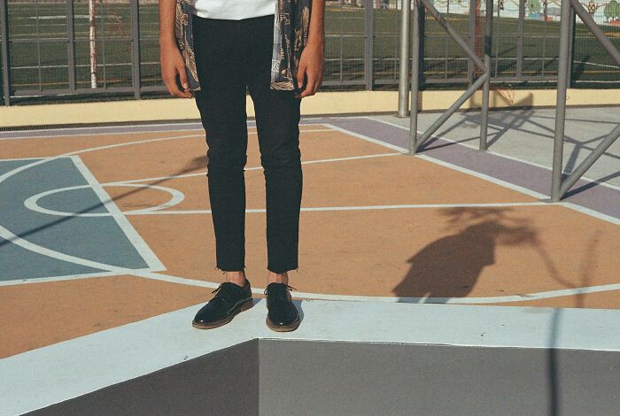 Person standing on a colorful court, highlighting genetic-balance in fashion and posture.