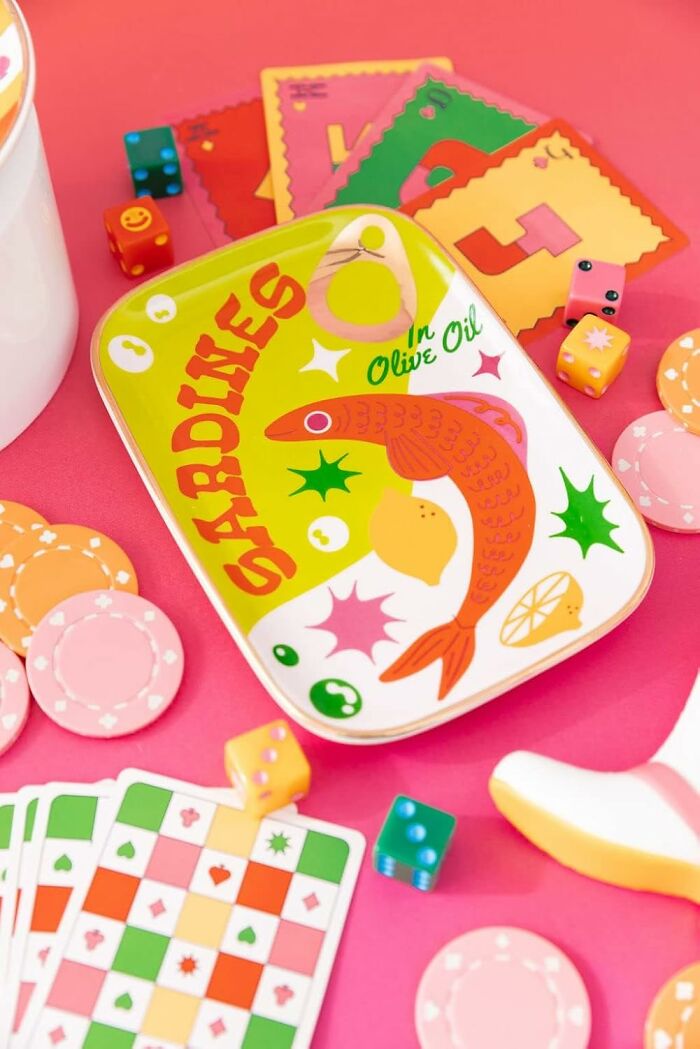Bando products with colorful cards, dice, and chips on a pink background.