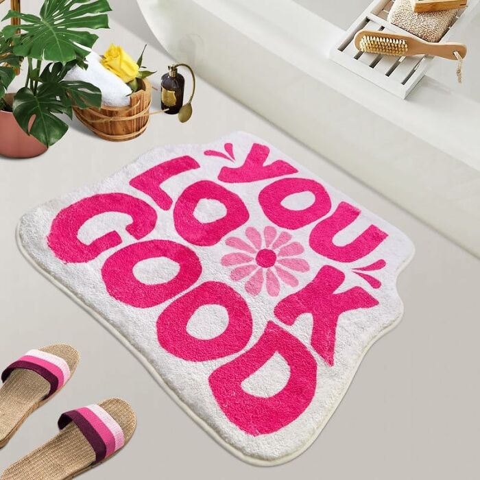 Bright bathroom mat with bold pink "You Look Good" text and flower design, enhancing bathroom style and comfort.