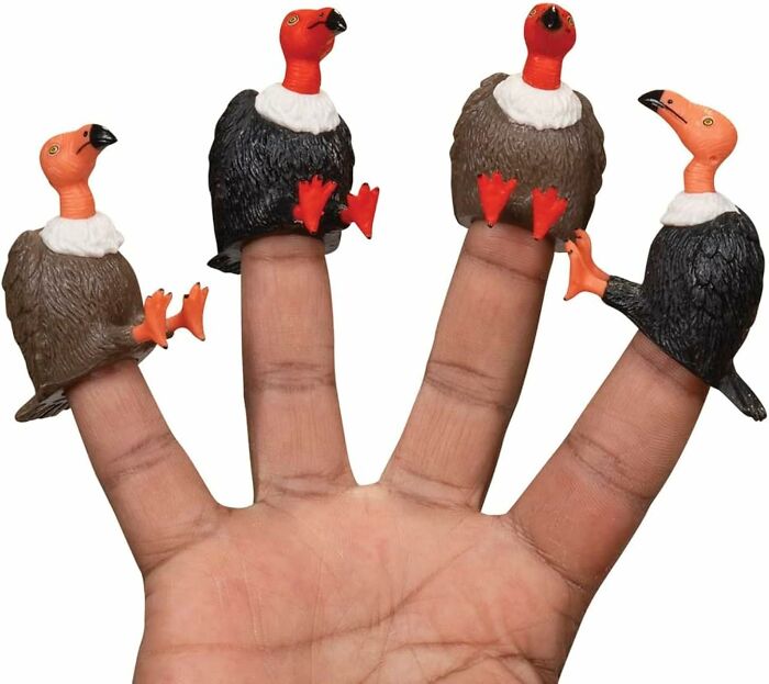 Hand wearing vulture finger puppets, showcasing quirky Archie McPhee items for fun and entertainment.