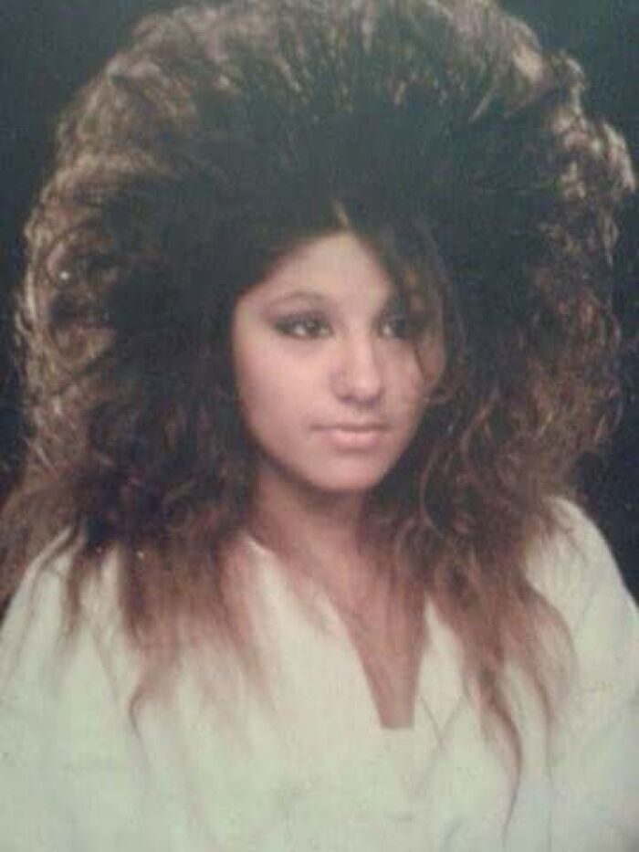 1980s woman with big, voluminous hair, embodying epic hair disasters of the era.
