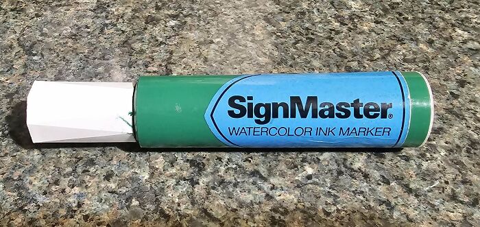 A SignMaster Watercolor Ink Marker, green and blue, on a speckled countertop. An example of a Buy It For Life purchase.
