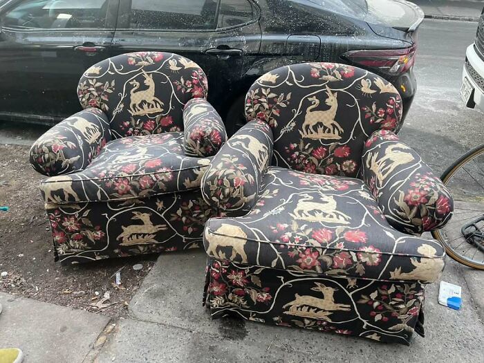 Patterned armchairs with unicorn and floral design left on NYC curb for “stooping” treasure seekers.