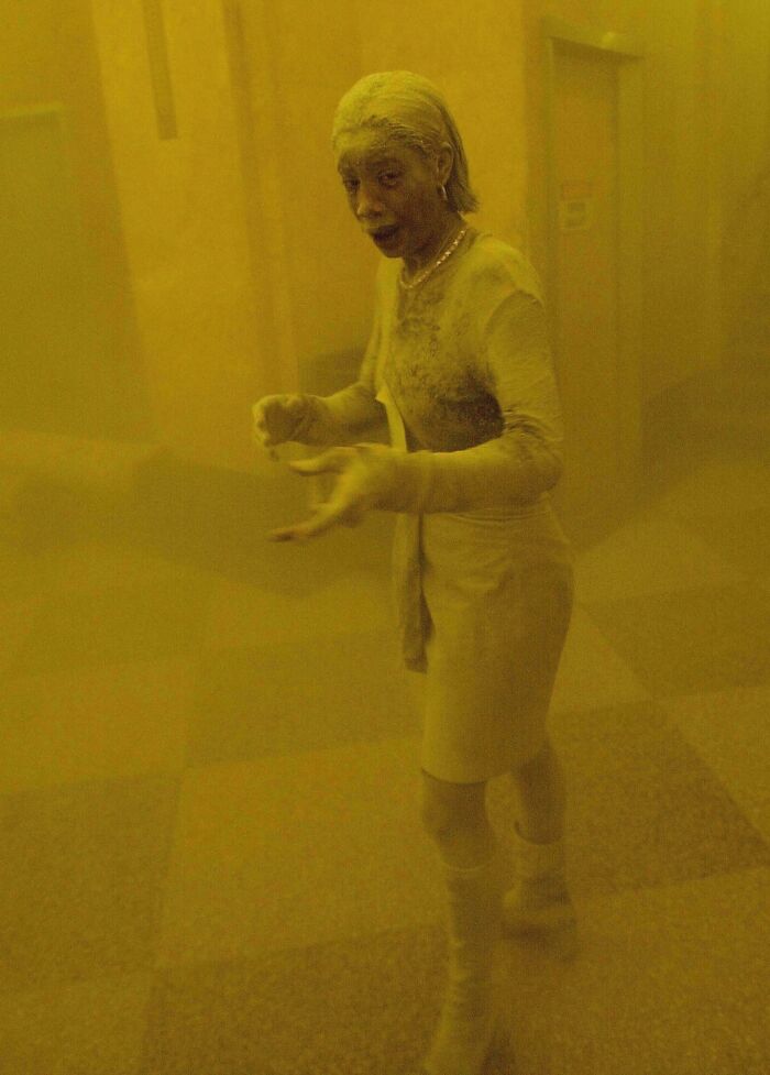 A woman covered in dust in a dimly lit historical photo, evoking a rare moment of world history.