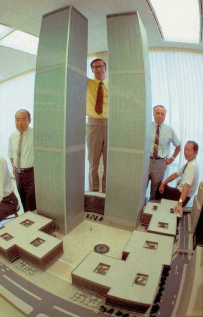 Architects with the rare model of the Twin Towers in an office setting.