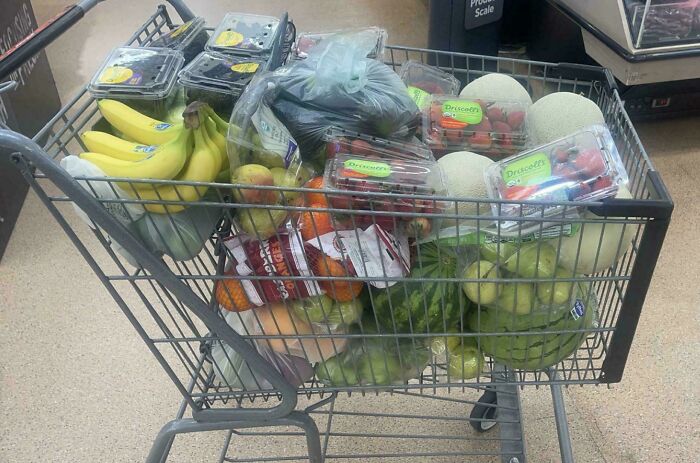 Shopping cart filled with various fresh produce, reflecting experiences of Instacart shoppers.