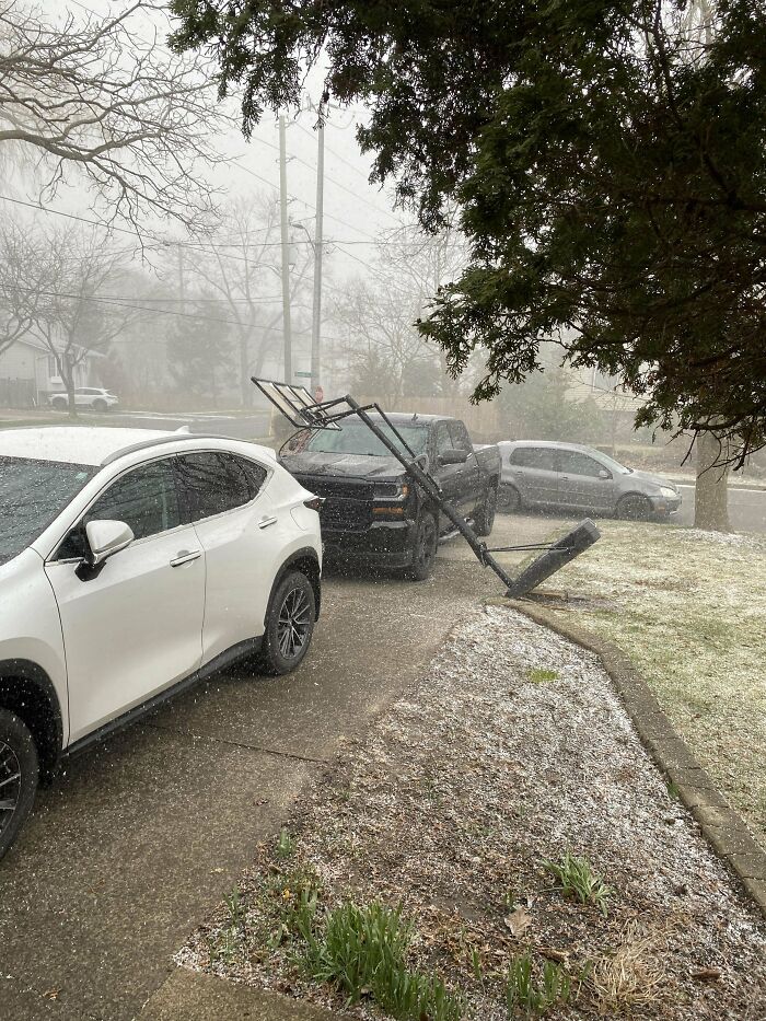 Cars parked in driveway with fallen basketball hoop; seen by Instacart Shoppers.