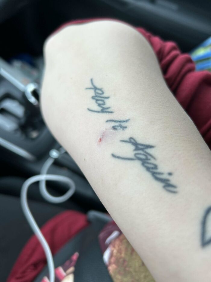 Tattoo on arm with script text, photo taken inside a vehicle for Instacart shoppers' stories collection.