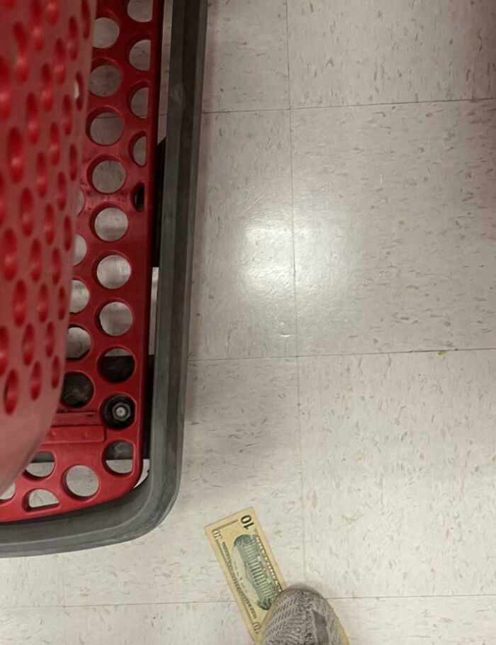 Shopping cart next to a $10 bill on a store floor, highlighting Instacart shoppers' unique experiences.