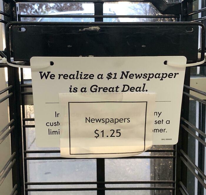 Newspaper sign: "We realize a $1 newspaper is a great deal" with a price listed as $1.25. Future predictions aged bad.