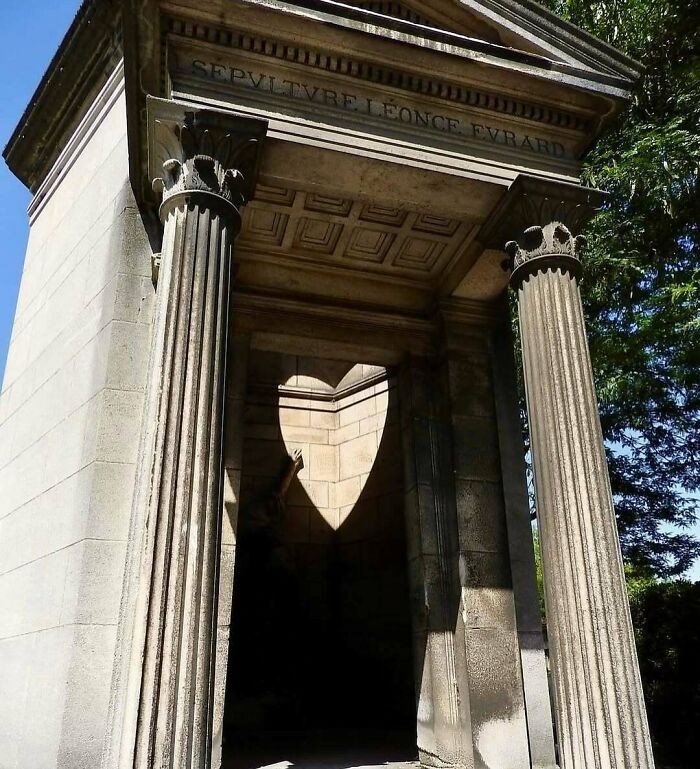 Stone monument with heart-shaped shadow creating an interesting and fascinating visual effect.