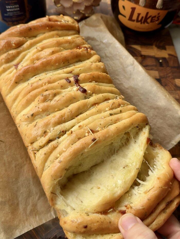 Freshly baked pull-apart bread with herbs and cheese, showcasing one of the incredible bakes deserving the spotlight.