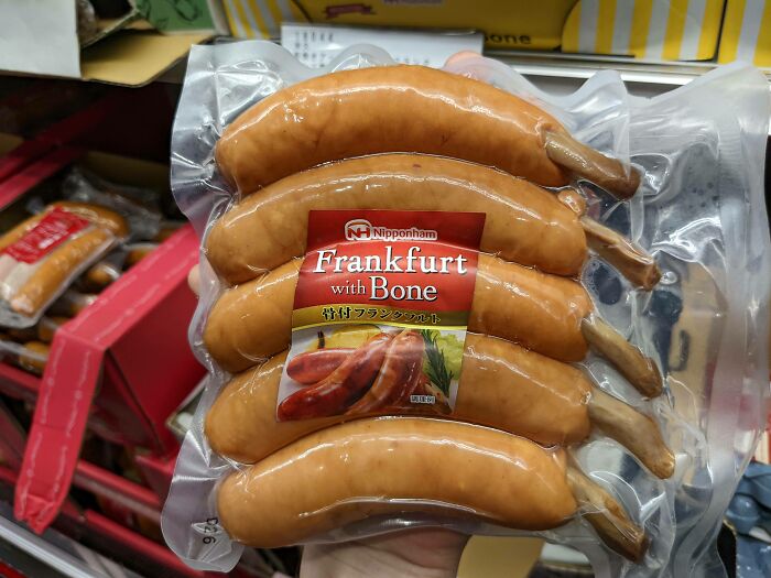 Packaged Frankfurt sausages labeled "Frankfurt with Bone" in a Japanese store.