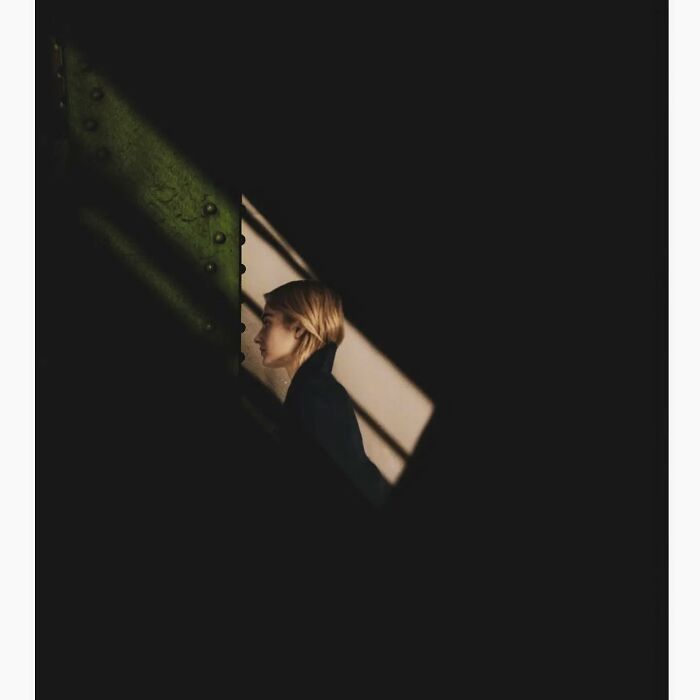 Person partially obscured by shadows in minimalist Tokyo setting, highlighting hidden side of city.