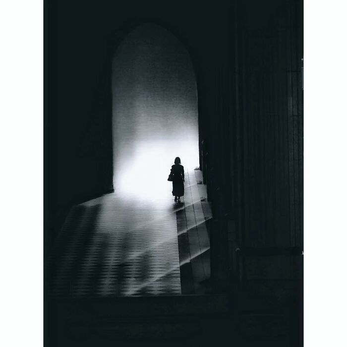 A person in a dimly lit passage captures a minimalist, hidden side of Tokyo.