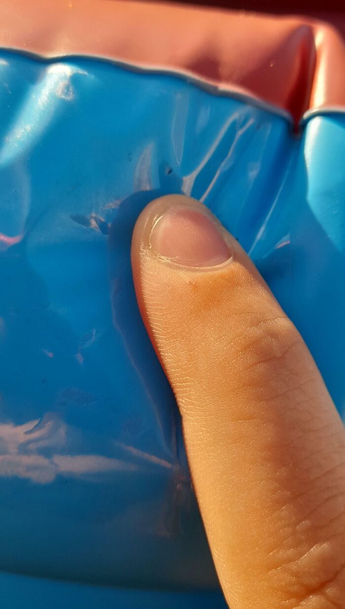 Close-up of a finger pressing a blue plastic surface, illustrating neighbors being so horrific people had to shame them.