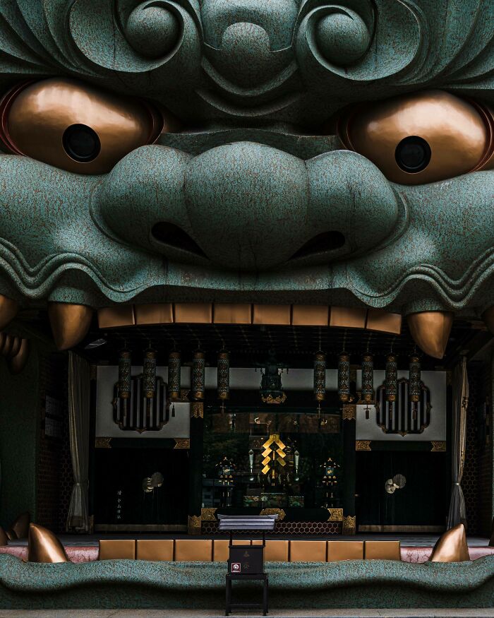 Temple entrance resembling a giant face in Japan, showcasing unique architecture and cultural artistry.