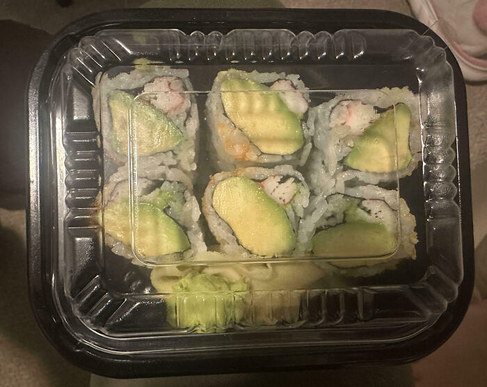Store-bought sushi tray with infuriating food scams, showcasing minimal filling and uneven ingredients.