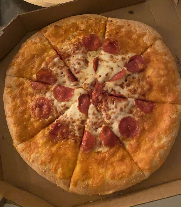 Pizza with uneven pepperoni distribution highlighting food scams.
