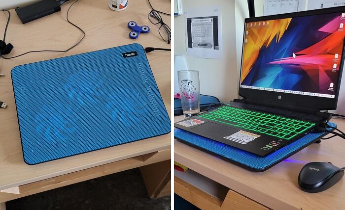 Laptop setup with cooling pad and mouse on a wooden desk, highlighting work from home tech essentials.