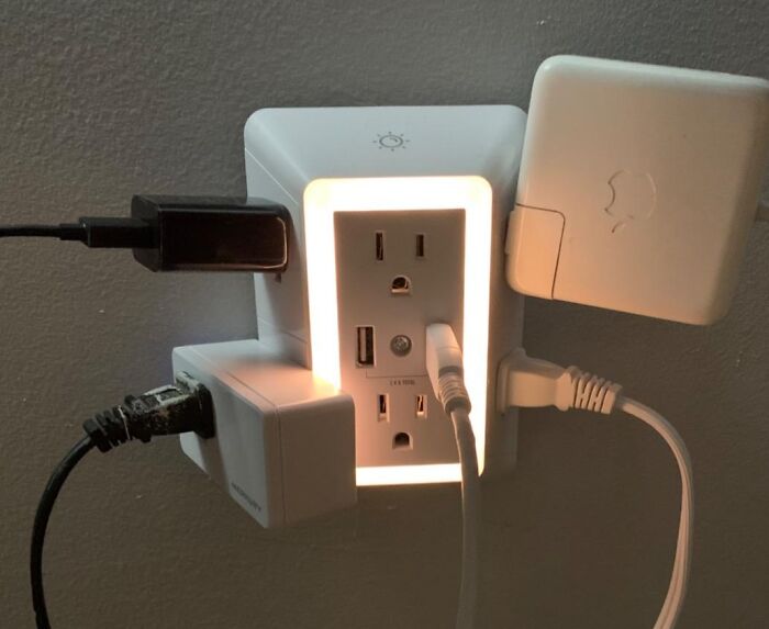 Plugged-in power hub with USB ports and cables, highlighting work from home tech essentials.