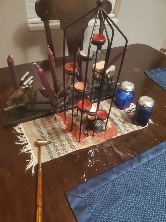 Candle display on table with wax spills, representing Valentines Day fails.