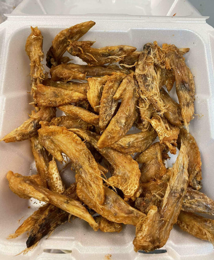 Crumbled dry fish pieces in a foam container, highlighting infuriating food scams.