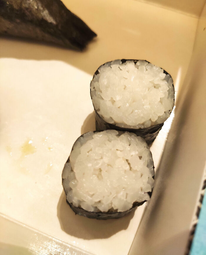 "Food scam showing sushi rolls filled almost entirely with rice, lacking expected filling content."