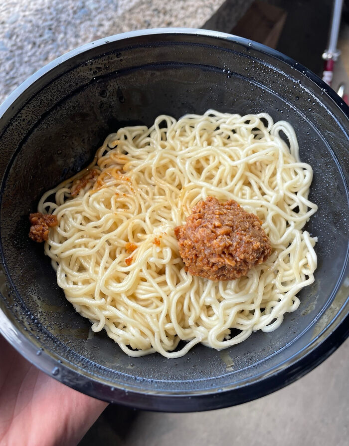 Bowl of plain noodles with a small portion of sauce, depicting food scams.