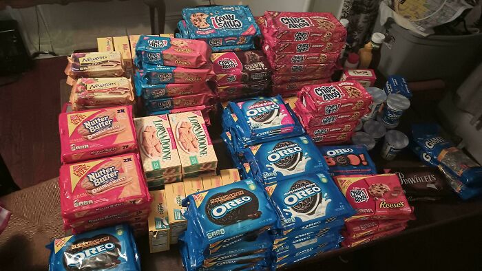 Stacks of assorted cookies and snacks found while dumpster diving.