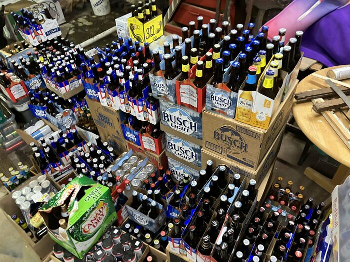 Stacks of beer bottles and cans found during dumpster diving haul.