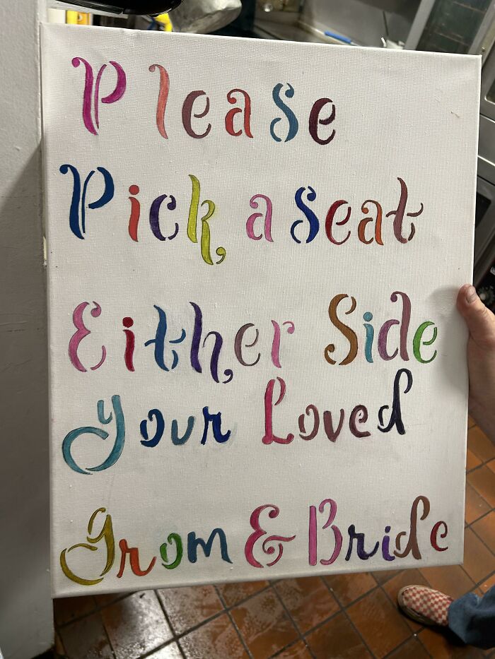 Colorful wedding sign with a spelling error prominent, showcasing budget-wedding-fails humor.