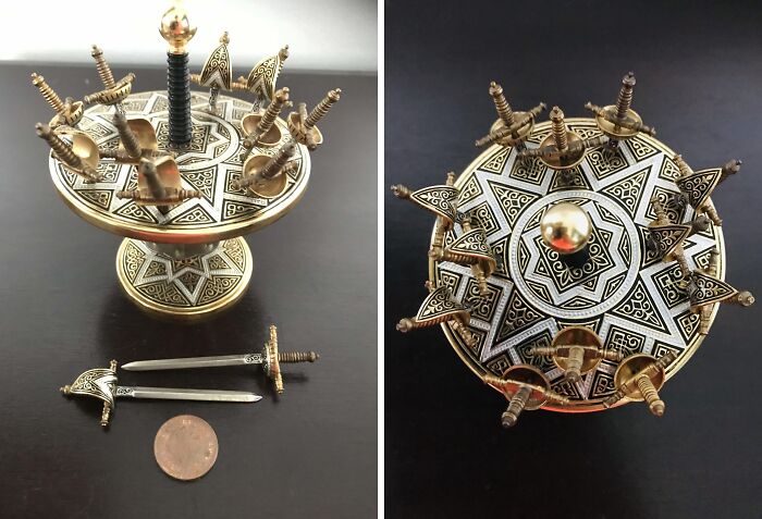 Intricate vintage sword holder with mini swords, showcasing cool old things in detailed metalwork design.