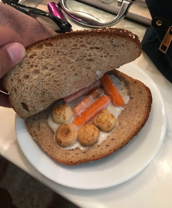 Unusual sandwich with carrots, mushrooms, and sauce between slices of bread, illustrating dumb-clueless-kids creativity.