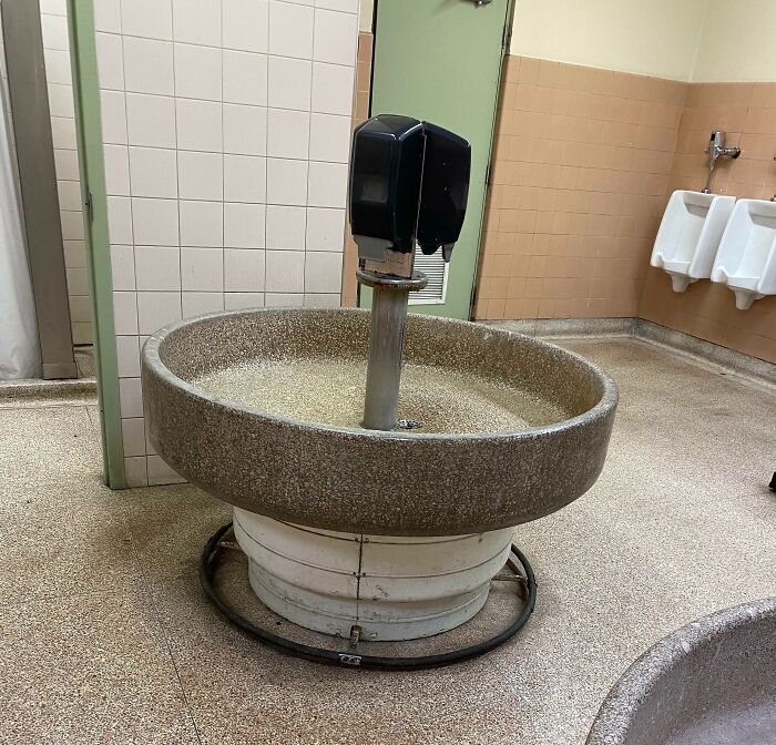Old-school wash station in a public restroom, reminiscent of past decades, sparking memories.