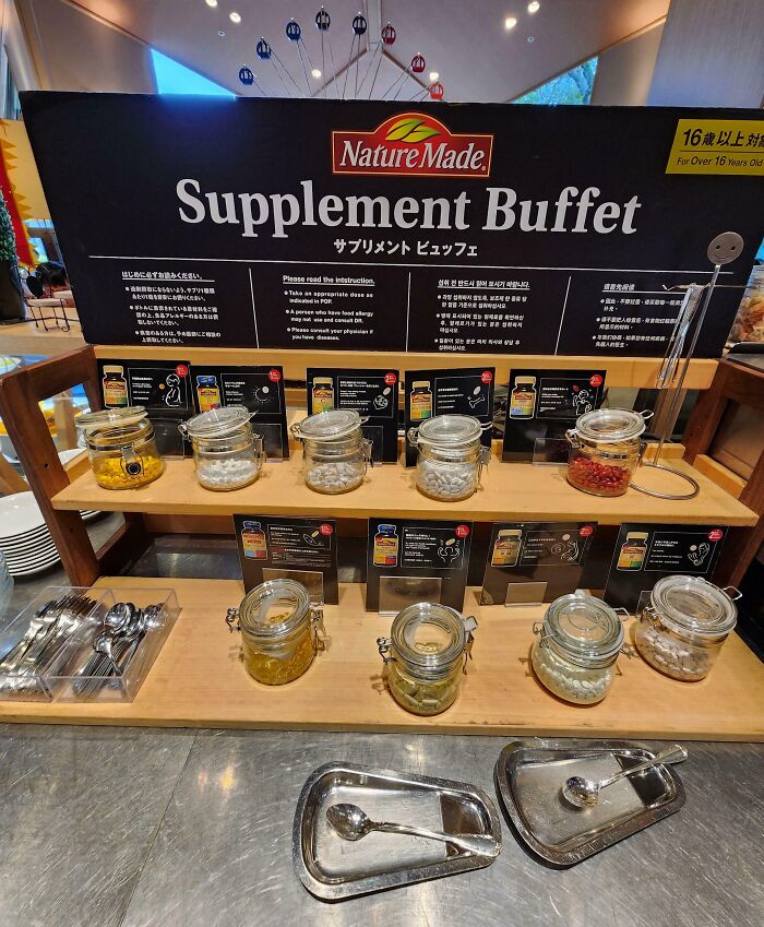 Supplement buffet display in Japan with jars of vitamins and instructions, showcasing an interesting part of Japanese culture.