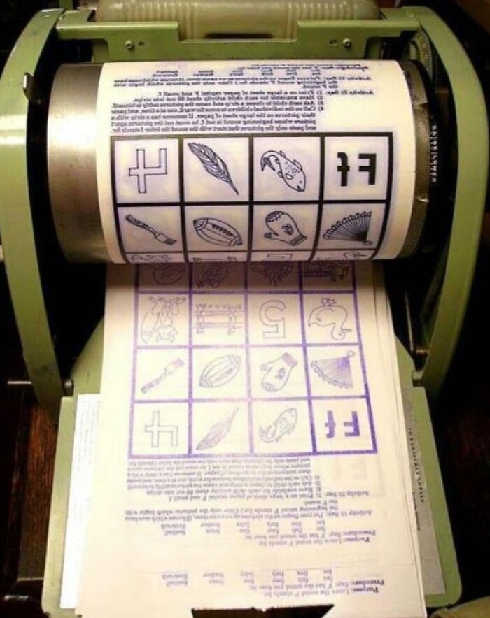Old-school mimeograph with printed sheets creating nostalgic memories.