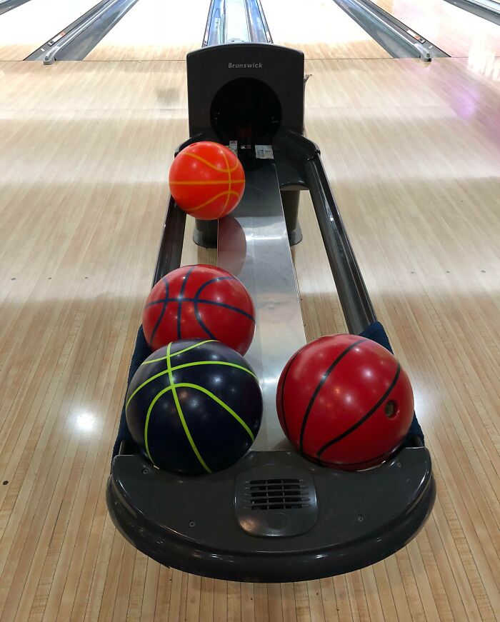 Bowling alley scene with basketball-themed bowling balls, showcasing Interesting Japan Pics.