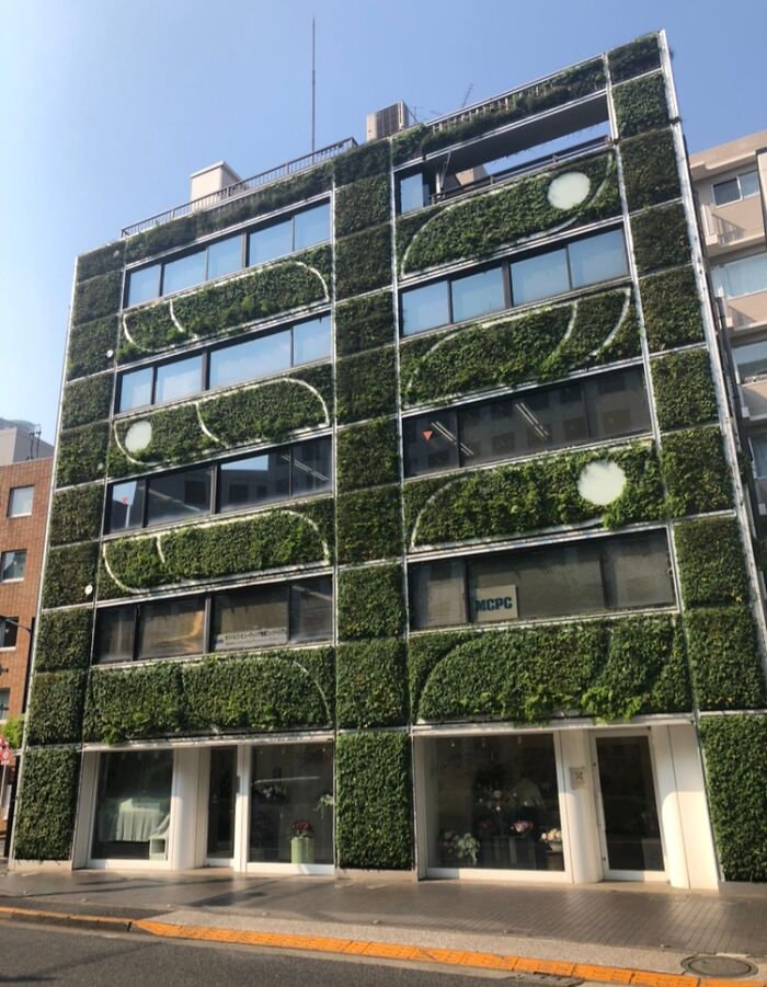 Vertical garden facade on a building in Japan, showcasing unique architectural design.