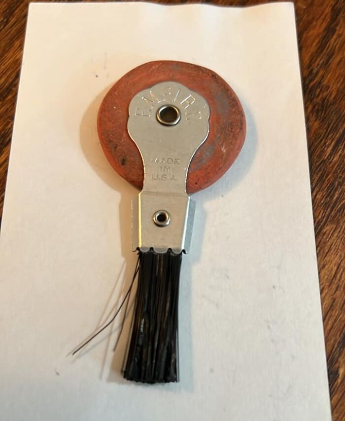 Old-school item with a retractable brush on a wooden table, evoking nostalgic memories of traditional tools.