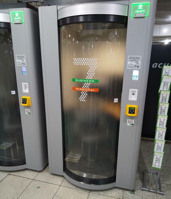 Modern Japanese phone booth with "Business" and "Personal" labels, displaying the number 7, vacant indicator lit.