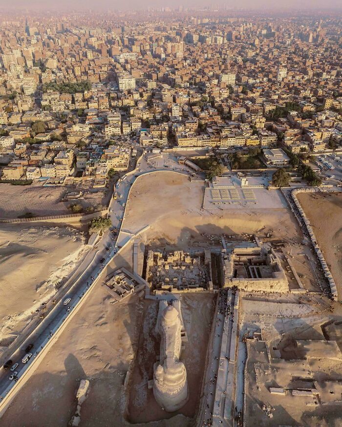 Aerial view of an urban landscape blending into an ancient site, showcasing an urban hell contrast.