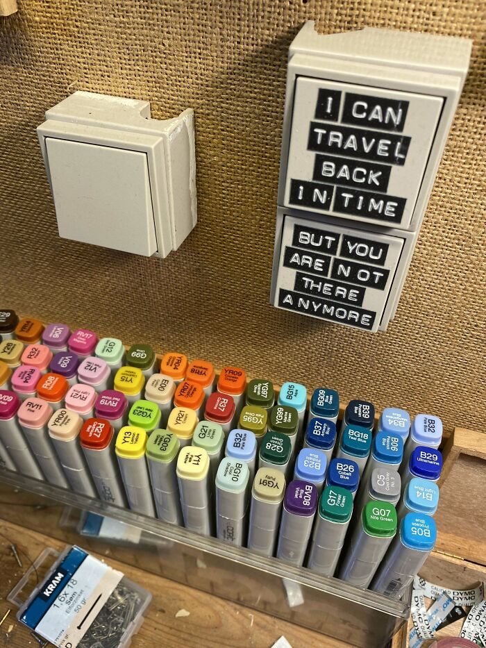 A display of colorful Buy It For Life markers and a magnet on a burlap board. The magnet reads: I CAN TRAVEL BACK IN TIME BUT YOU ARE NOT THERE ANYMORE.