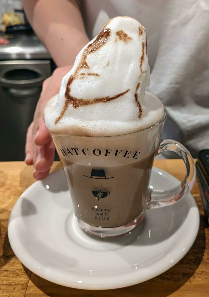 3D latte art in a Japanese coffee shop, featuring a sculpted foam design on top of a cappuccino.