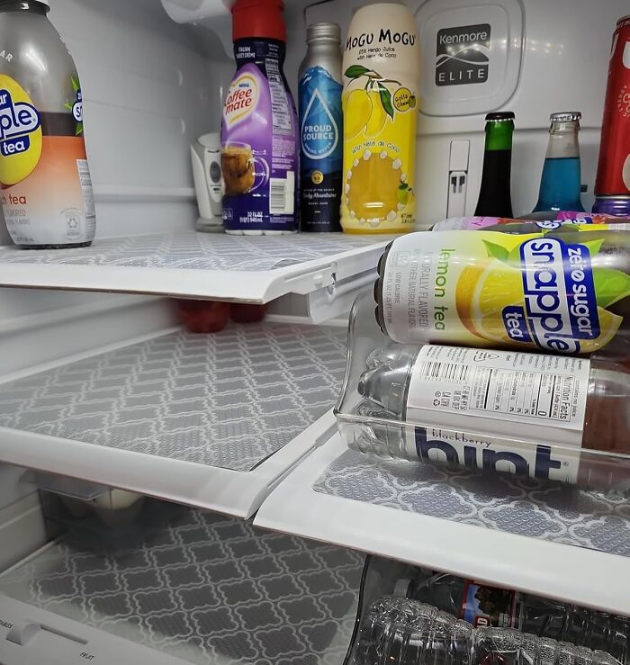 Refrigerator with neatly arranged drinks, showcasing useful things that also look nice.