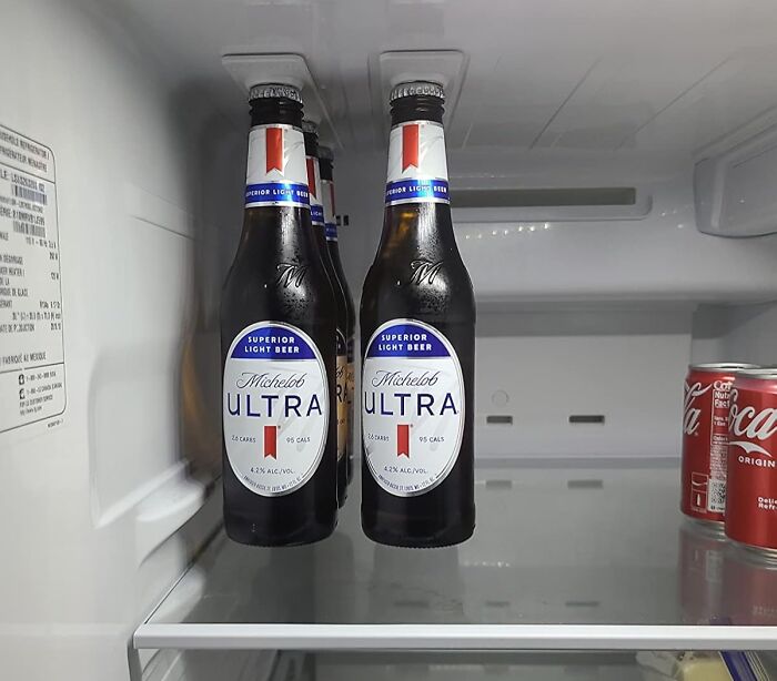 Bottles of beer and soda arranged aesthetically in a fridge, combining usefulness and style.