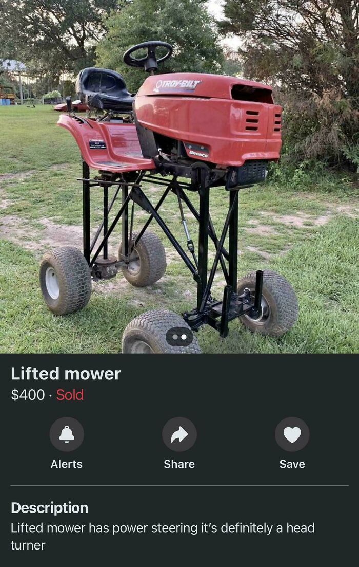 Lifted lawn mower with tall wheels on grass, illustrating innovative Florida wild moments in design.