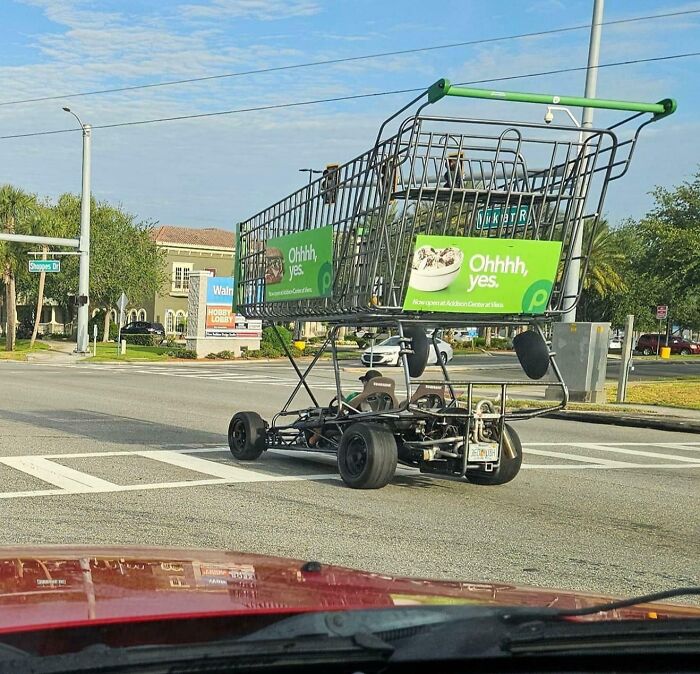 Giant shopping cart vehicle on a Florida street, capturing a wild moment in everyday traffic.