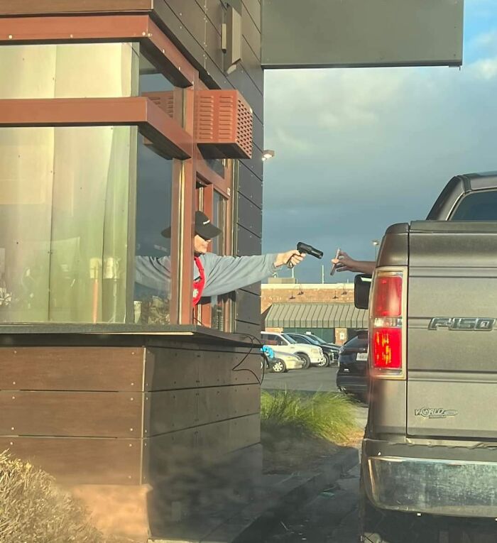 Drive-thru worker humorously uses a barcode scanner, leading to hilarious misunderstandings with a truck driver.